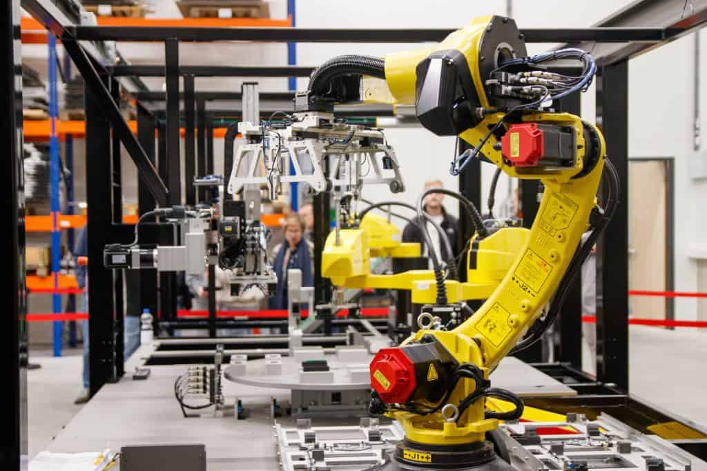 AI explained - industrial robot arm in manufacturing facility, physical AI and automation news today