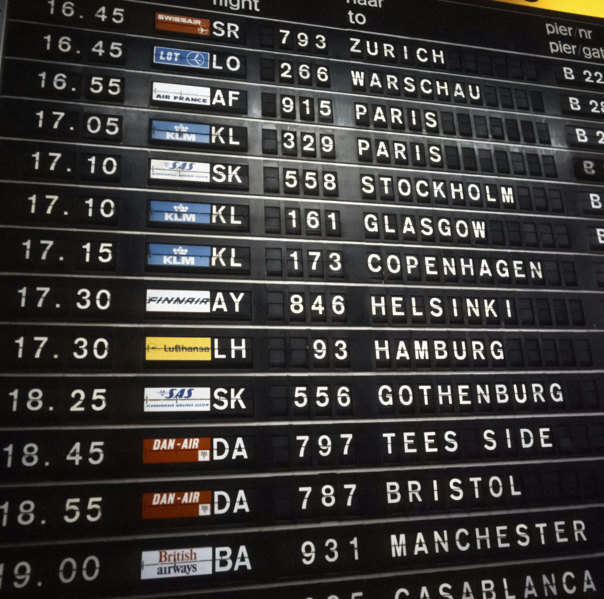 Airport departure board showing flight delays