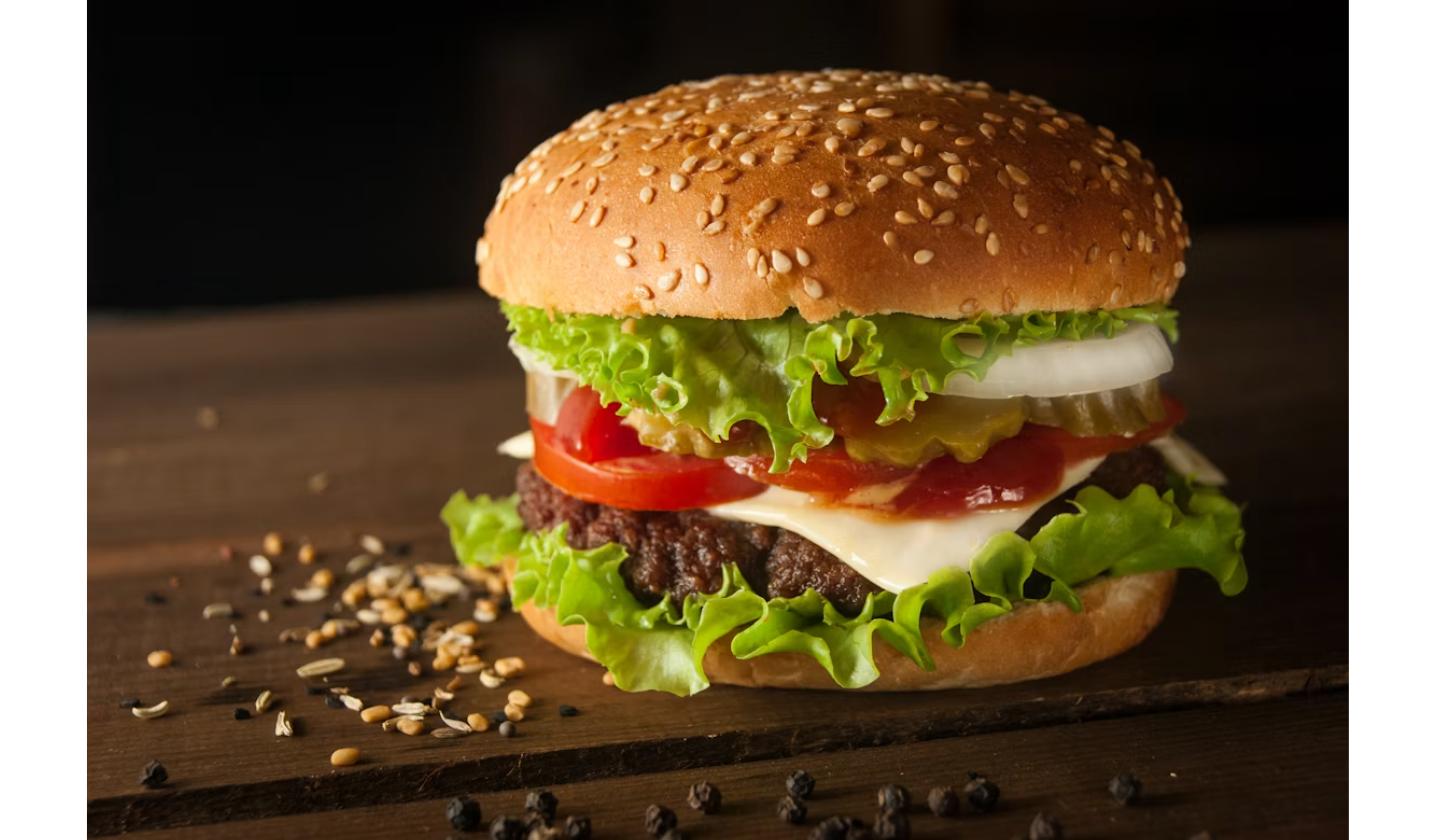 Burger with sesame bun representing Burger King's Whopper comeback in today's 60-second news roundup