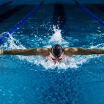 Swimmer competing in the pool at the Commonwealth Games 2026 in Glasgow, part of the medal-winning swimming program