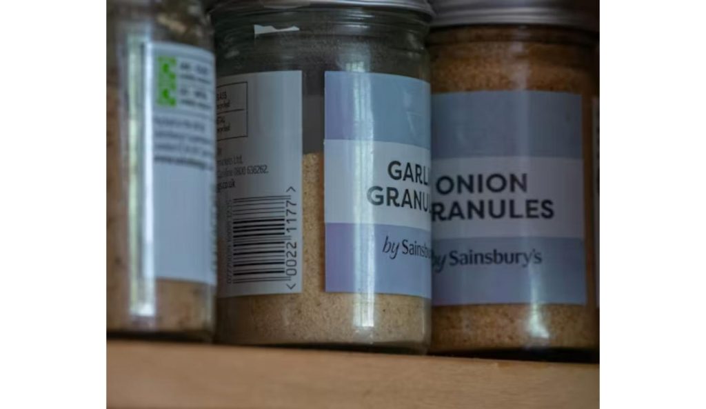 Jars of garlic and onion granules on a pantry shelf, similar to the recalled seasoning product