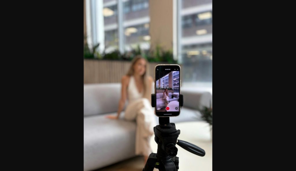 Content creator filming a vertical video, demonstrating how to go viral on social media using TikTok