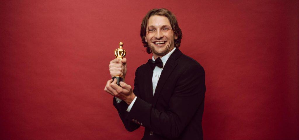 Entertainment news today - actor holding an award on the red carpet