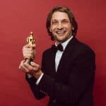Entertainment news today - actor holding an award on the red carpet