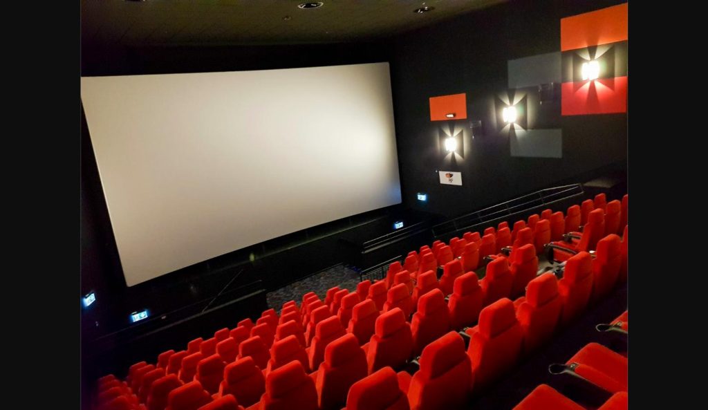 Empty IMAX-style movie theater screen, symbolizing the Odyssey movie leak that spread online