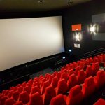 Empty IMAX-style movie theater screen, symbolizing the Odyssey movie leak that spread online
