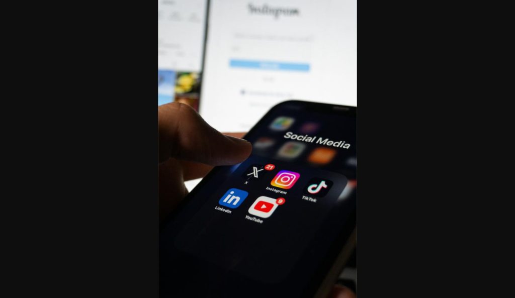 Phone screen showing social media apps, illustrating how the Odyssey movie leak spread virally on X