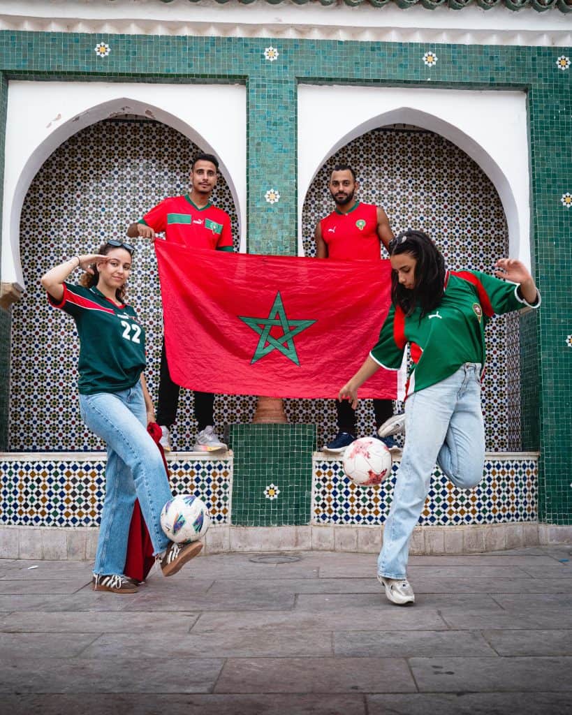 Moroccan football fans proudly display their national flag while celebrating their team’s passion and unity ahead of the France vs Morocco showdown.