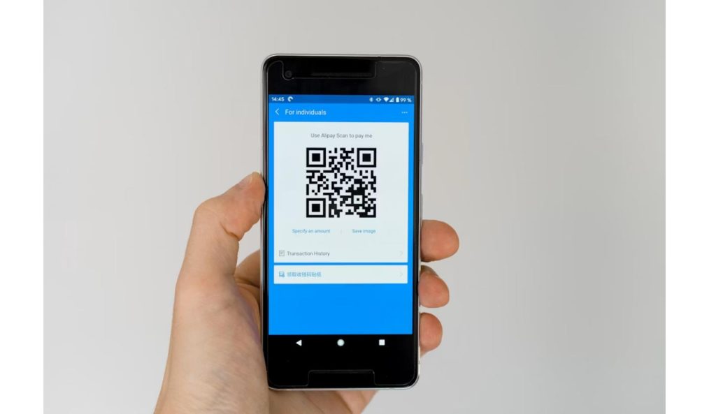 Hand scanning a QR code on a smartphone, similar to redeeming the Burger King Whopper Guarantee