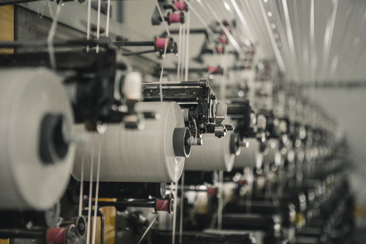 Textile manufacturing machine with yarn spools used in smart fabric technology
