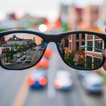 City street reflected in smart glasses lenses, representing next-gen wearable tech