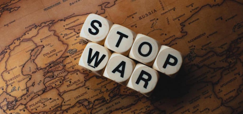 World news today - stop war dice on a world map symbolizing global conflict
