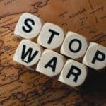 World news today - stop war dice on a world map symbolizing global conflict