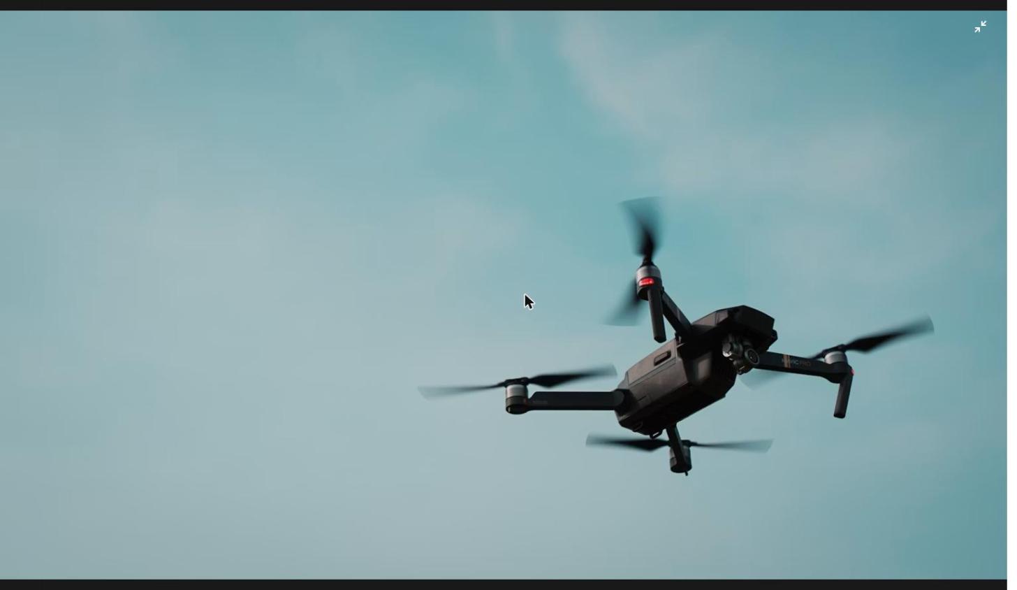 Egypt tanker drone attack: black quadcopter drone in flight over the sea, illustrating the strike on tankers at Damietta port