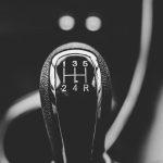Close-up of a manual gear shifter, symbolizing the McLaren McL 6GT's return to manual transmission