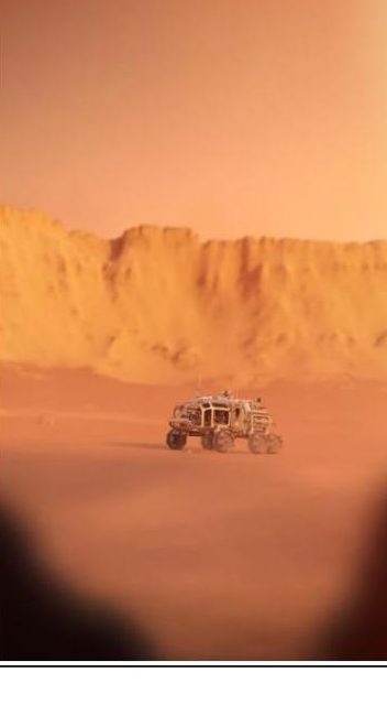 Perseverance rover Mars driving record photo of a rover crossing a dusty desert landscape